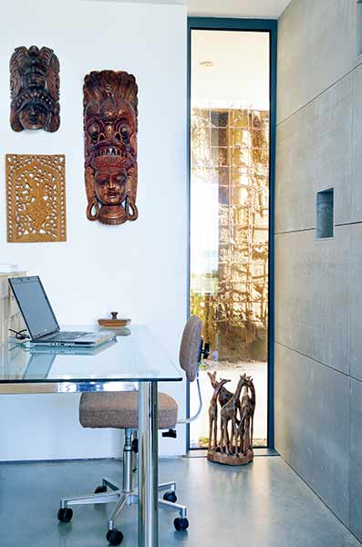 A linear picture window offers glimpses to other rooms in this project on the coast