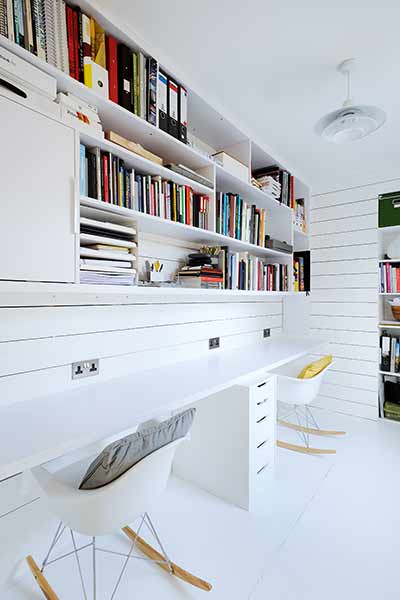 White timber cladding on the walls lend a Scandinavian style to this home office