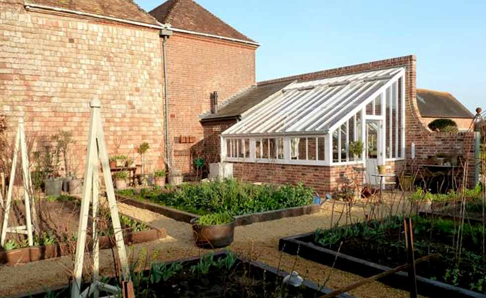 white cottage victorian greenhouse vegetable garden