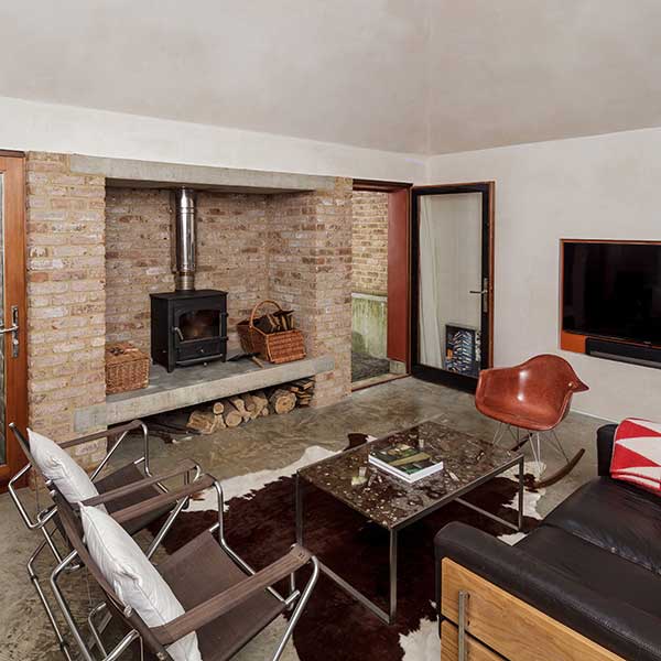 stone fireplace with log burner and living space