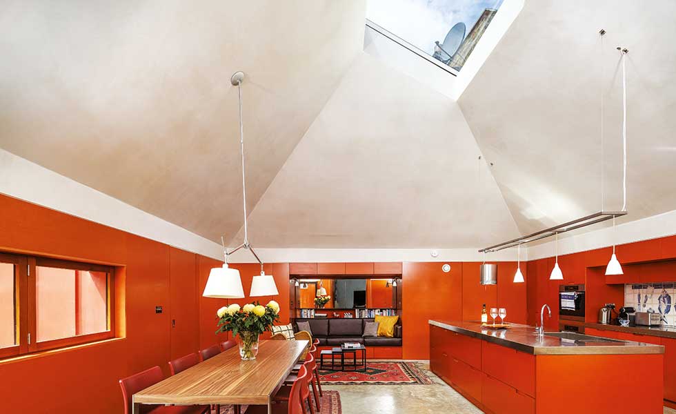orange kitchen diner with a pyramid vaulted ceiling