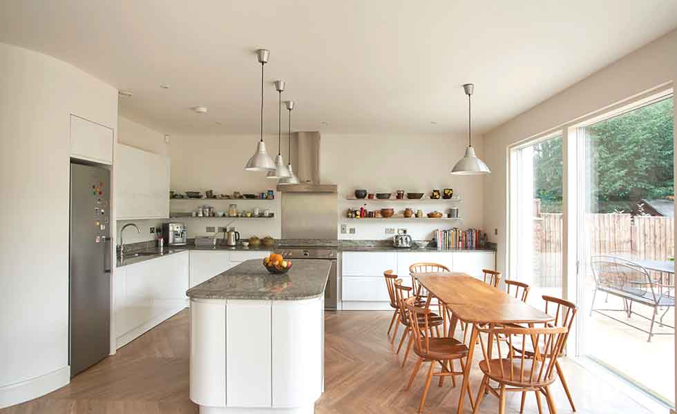 Open shelving adds interest in this modern kitchen which opens out to a terrace