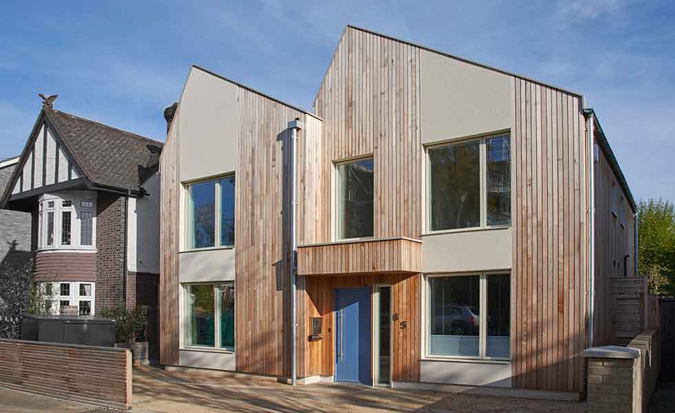 Long cedar panels break up the external facade of this prefabricated timber frame home