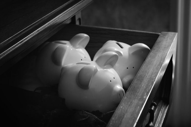 File image of Three piggy banks tucked in a drawer