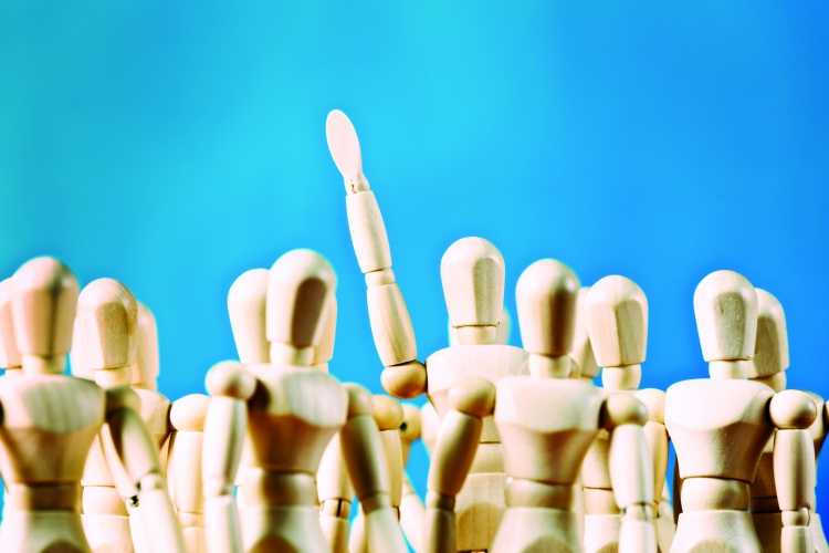 Standing out from the crowd, single figure raising arm