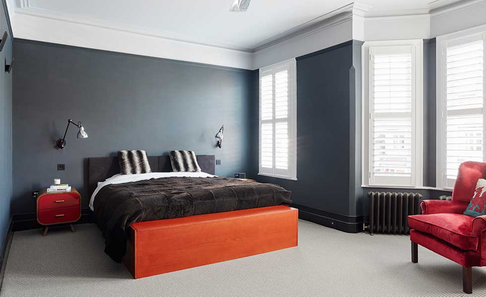 dark bedroom with red accessories