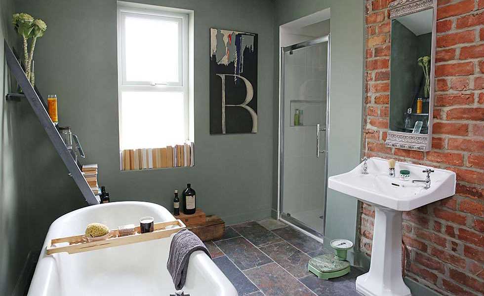 bathroom with an exposed brick wall