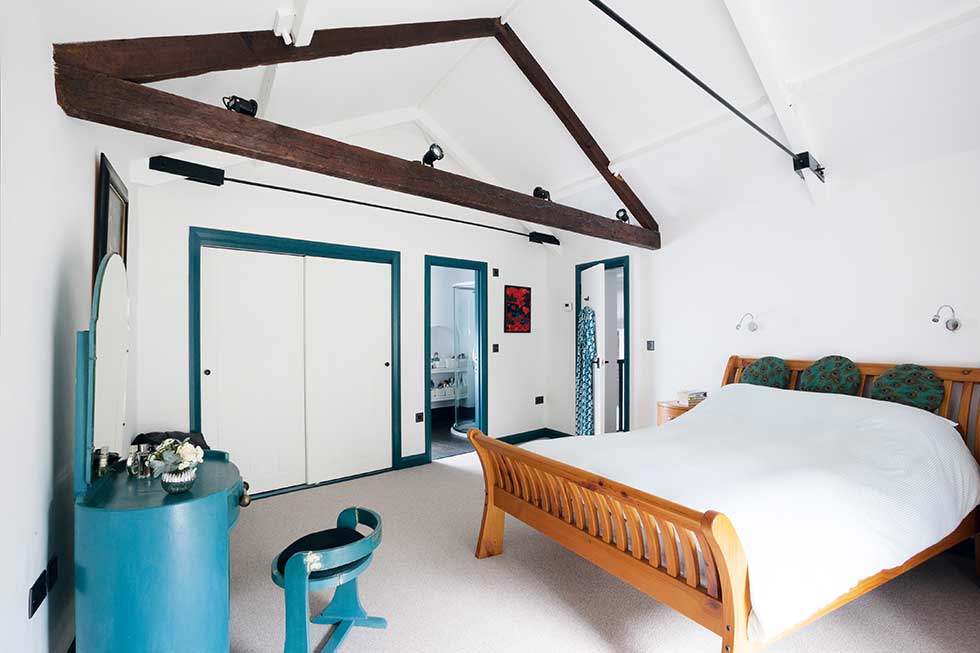 converted coach house with a scandinavian style bedroom