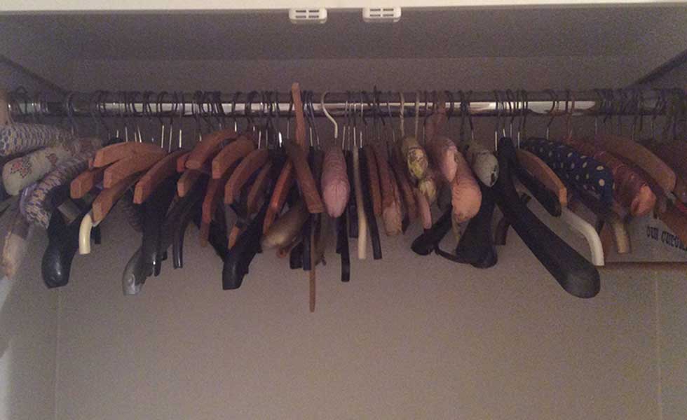 cluttered wardrobe of coat hangers