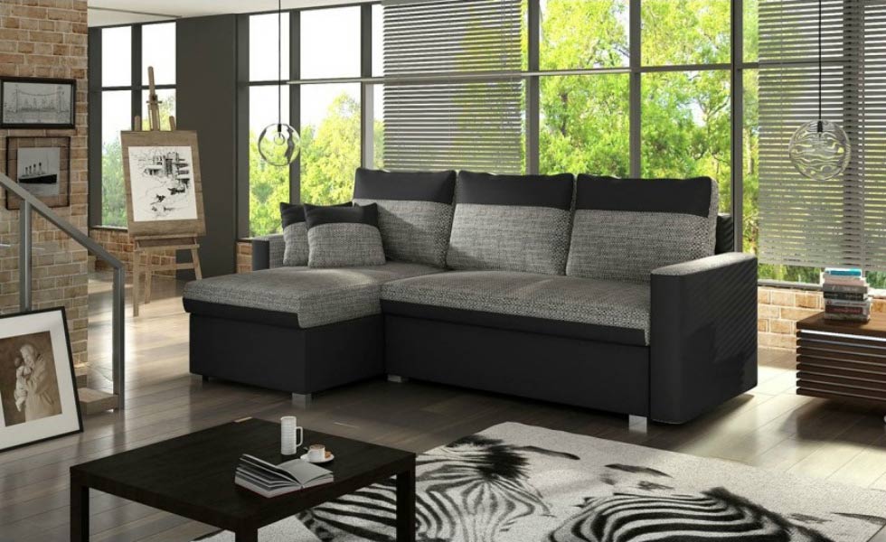 The Pescara Corner Sofa Bed is covered in black faux leather and grey fabric. It includes storage space and costs £639.95