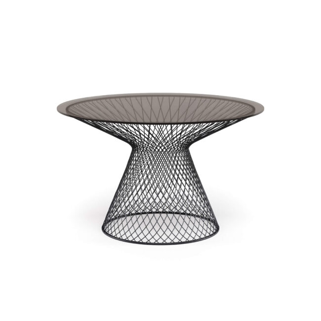 The Heaven round table, diameter 120 cm, with glass top and designed by Jean-Marie Massaud, celebrates lightness and timeless elegance. The base, made with slender woven and hot-galvanized steel profiles, creates a refined interplay of lines and voids that captures the eye, defining a harmonious and modern silhouette. The tempered glass top, available in two colors, illuminates the environment and gives a sense of almost intangible lightness. Heaven transforms every space into an elegant and cozy place, where contemporary design and harmony meet, becoming the refined heart of every convivial moment.