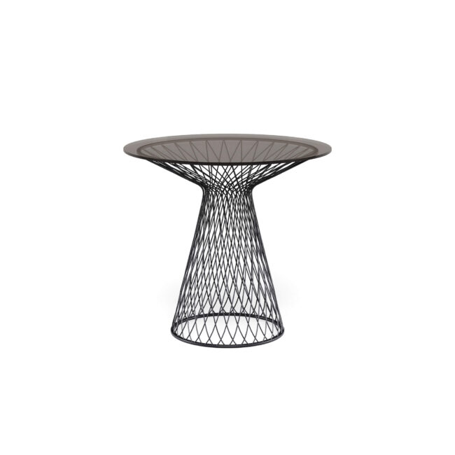 The Heaven round table, diameter 80 cm, with glass top and designed by Jean-Marie Massaud, is an ode to lightness and timeless elegance. The base, made with woven and hot-galvanized steel profiles, creates a refined interplay of lines and voids that captures the eye and gives the table a harmonious and modern silhouette. The tempered glass top, available in two different colors, adds a touch of brightness and lightness, making the environment even more refined. Heaven transforms every space into an elegant and cozy place, where contemporary design and lightness merge in perfect harmony, becoming the star of every convivial moment.