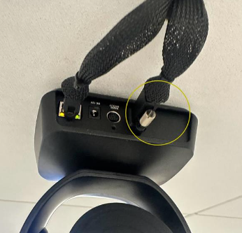 A black object with a black strap attached to it

Description automatically generated