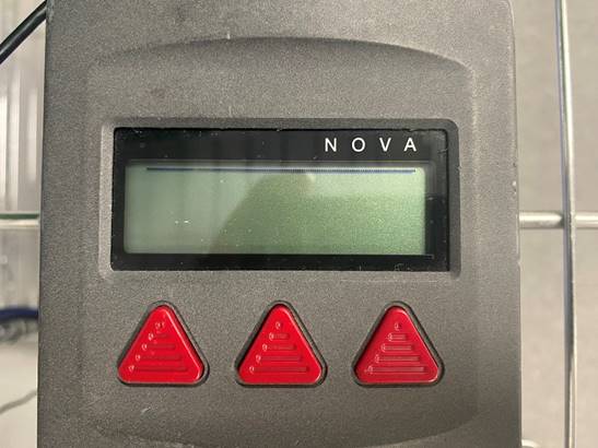 A grey device with a screen and red buttons

AI-generated content may be incorrect.