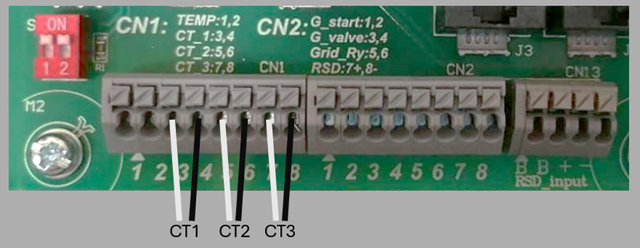 Title: Close-up of a circuit board with wires
Description automatically generated