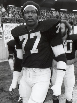 OAKLAND, CA - DECEMBER 29: Bubba Smith #77 of the Oakland Raiders looks on before the 1974 AFC Championship game against the Pittsburgh Steelers at the Oakland Alameda Coliseum on December 29, 1974 in Oakland, California. The Steelers defeated the Raiders 24-13. (Photo by Michael Zagaris/Getty Images)