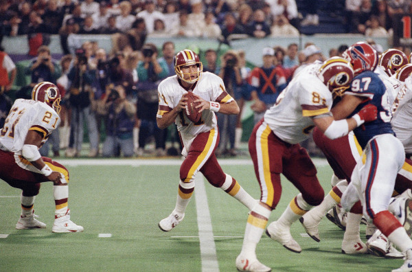 Washington Redskins Don Warren (85) keeps Buffalo Bills Cornelius Bennet (97) away from Redskins quarterback Mark Rypien during second quarter action Super Bowl XXVI football game in Minneapolis, on Sunday, Jan. 27, 1992. (AP Photo/Jim Mone)