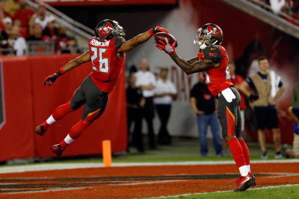 The Buccaneers’ Ryan Smith (29) and Josh Robinson (26) keep the ball out of the end zone on a punt while Alan Cross (not pictured) downs it at the 1-yard line against the Saints Dec. 11. Photo: Mark LoMoglio/Getty Images