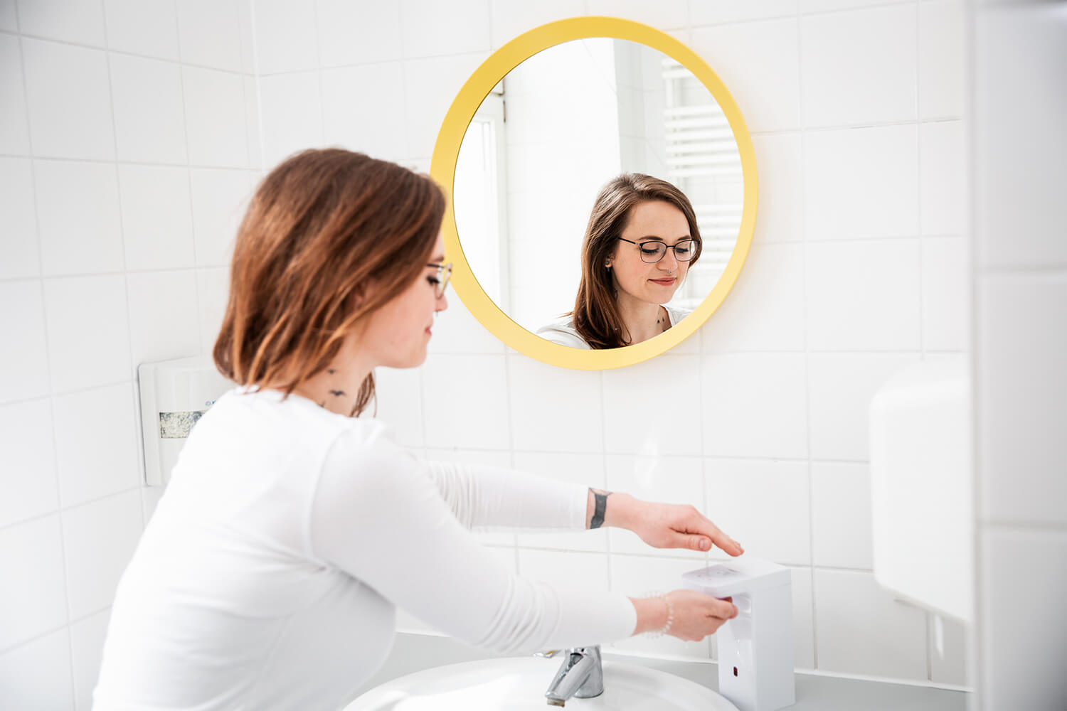 Junge Frau desinfiziert ihre Hände.