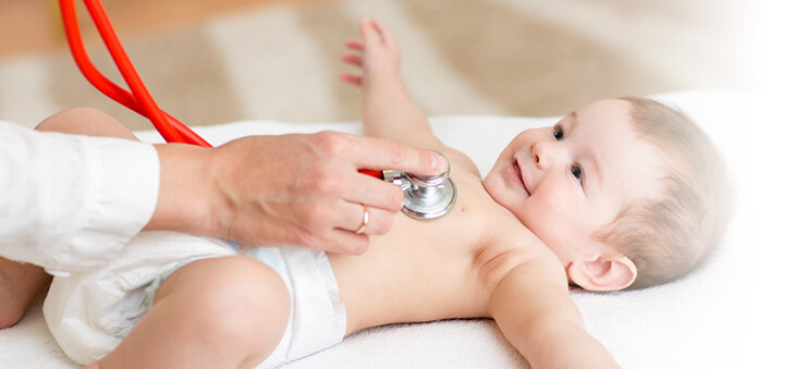 Baby wird an der Brust mit Stetoskop abgehört.