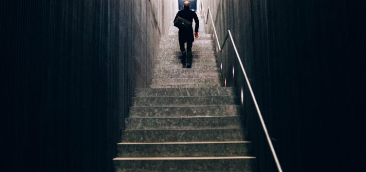 man with bag climbing stairs