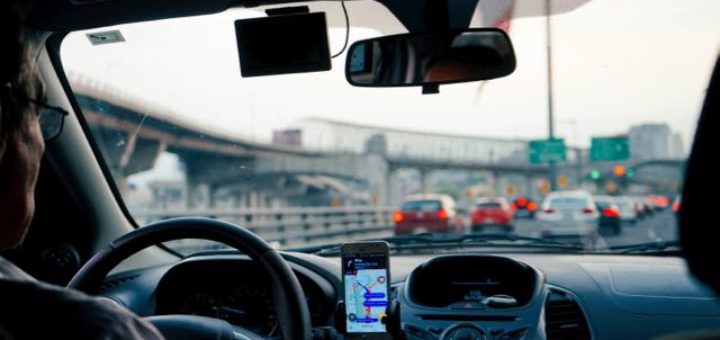man driving in traffic with GPS