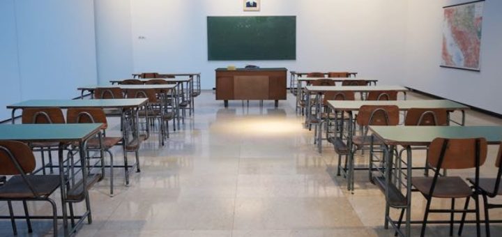 classroom with green board and map