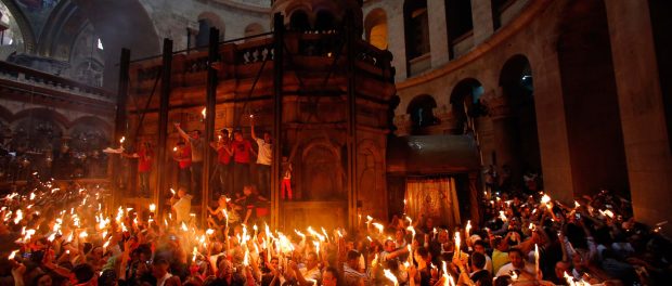 Worshippers hold candles as they take part in the Christian Orthodox Holy Fire ceremony at the Church of the Holy Sepulchre in Jerusalem's Old City