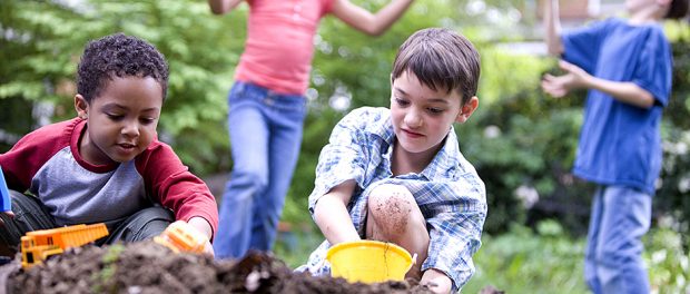 Two caucasian and two african American children playing together