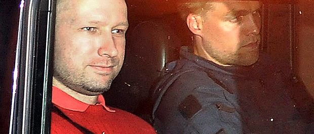 Bomb and terror suspect Anders Behring Breivik (red top) leaves the courthouse