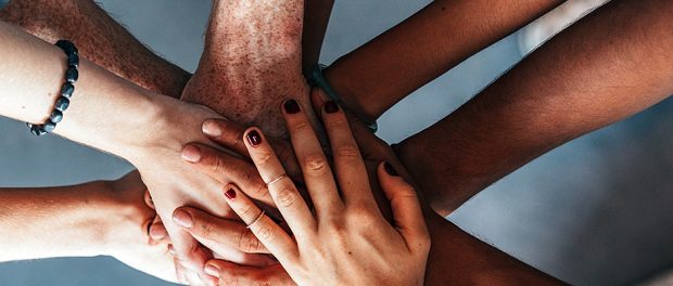 Stack of hands showing unity