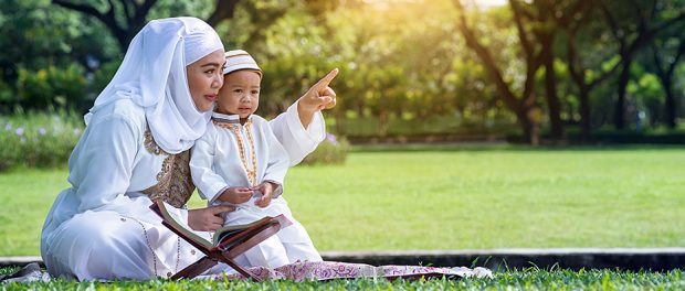 Asian Muslim mother and her son enjoying quality time at park, M