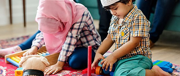 Muslim family relaxing and playing at home