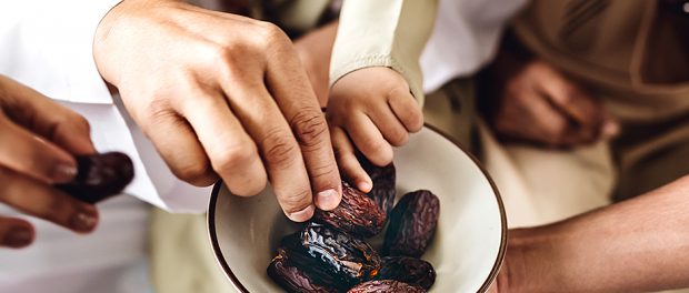 People sharing some dried dates