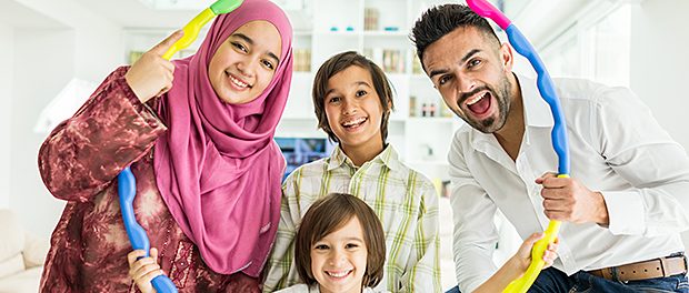 Happy Arabic Muslim family at modern home having fun and good ti