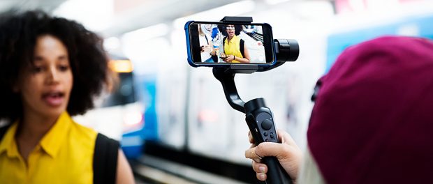 Young adult woman traveling and vlogging social media concept