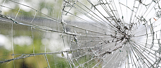 Old cracked dirty broken glass window background.