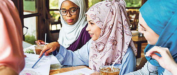 Islamic friends discussing and reading books together