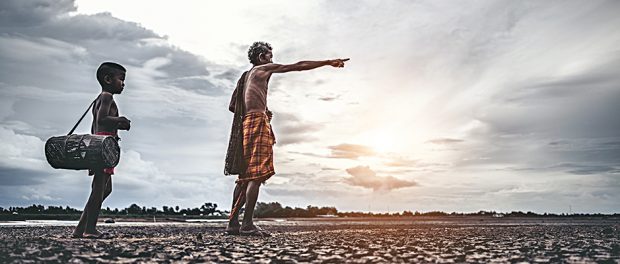 Elderly men and boy find fish on dry ground,global warming