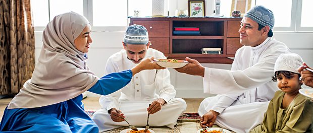 Muslim family having dinner on the floor