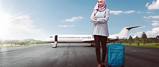 Young asian female muslim with suitcase going traveling