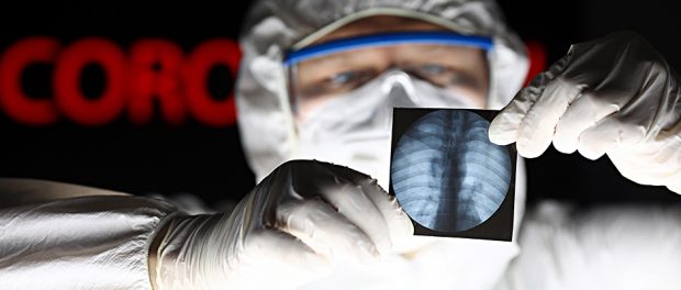Male doctor wearing protective suit mask and gloves