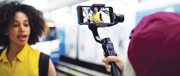 Young adult woman traveling and vlogging social media concept