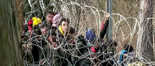 Abstract, blurry, out of focus image for media and internetа. A group of unorganized people are trying to illegally cross the border.