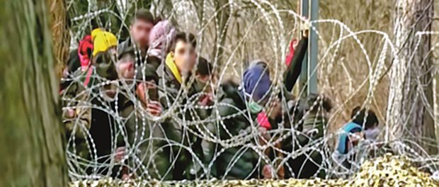 Abstract, blurry, out of focus image for media and internetа. A group of unorganized people are trying to illegally cross the border.