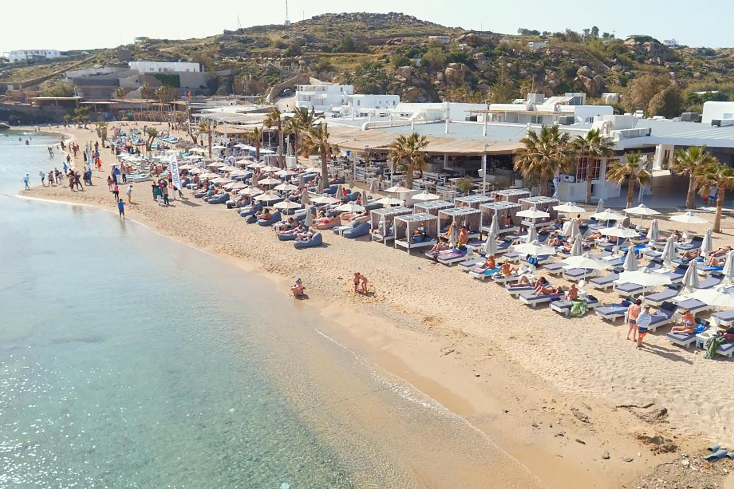 The crowd is young and beautiful, multi-culti and unpretentious, free and wild, sipping every last drop of this unique fun experience on one of the most beautiful beaches in the world, serving as the perfect background for your newly built summer memories. - Secondary Image