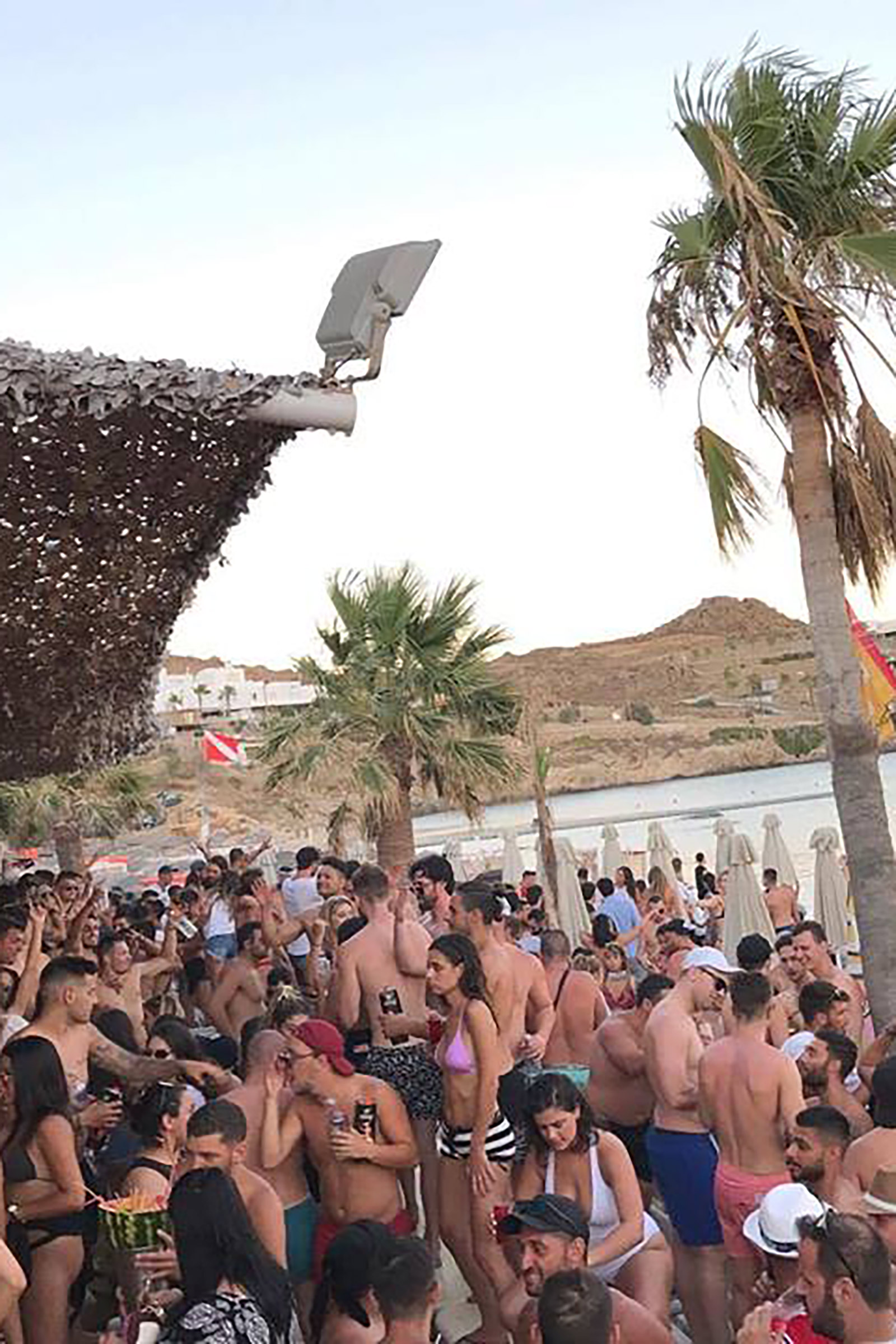 Sexy girls and super-tanned boys dancing on the bars and the tables, on the sand and the deck, professional dancers giving the tempo with sensuous moves and the amazing resident DJ set or the frequently invited world-famous guest DJs setting the place on fire. - Image