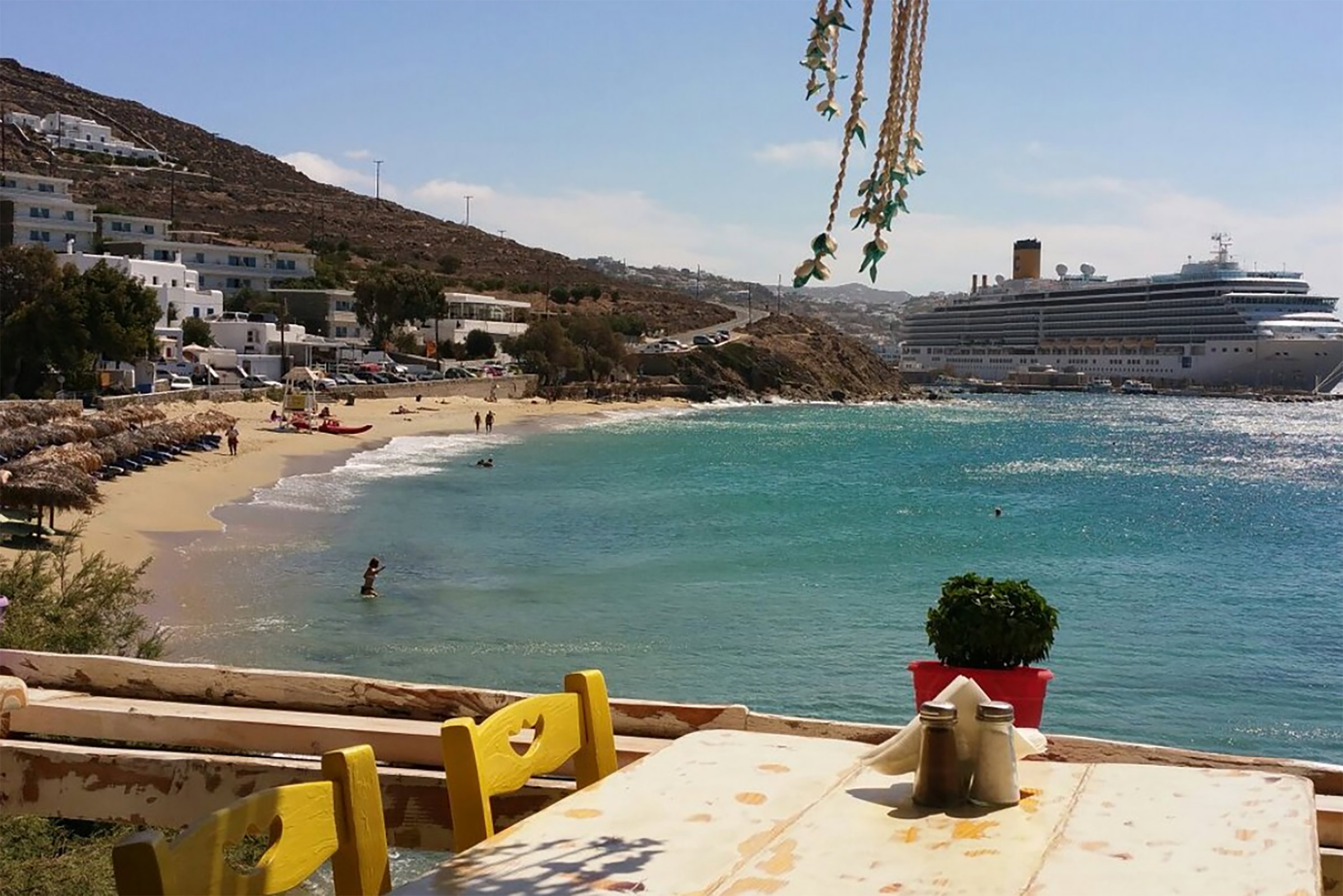 Located on the far end of the beautiful Aghios Stefanos beach, Taverna Petran (which actually means Peter’s tavern) is a typical Greek tavern on the sea, featuring whitewashed interiors, white wooden tables and traditional wood and wicker chairs and serving traditional taverna dishes. - Secondary Image