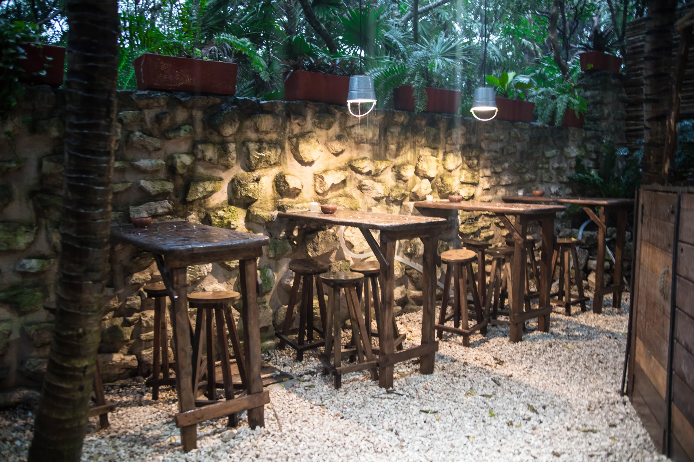 Authentically simple, both in aesthetics and cuisine, this palapa-housed restaurant reflects the true feeling of the Tulum jungle and the local culinary traditions. A few small tables under the overgrown trees and the extent use of wood allow Kitchen Table to be totally in tune with its natural surroundings, while using solar power for a sustainable future. - Secondary Image