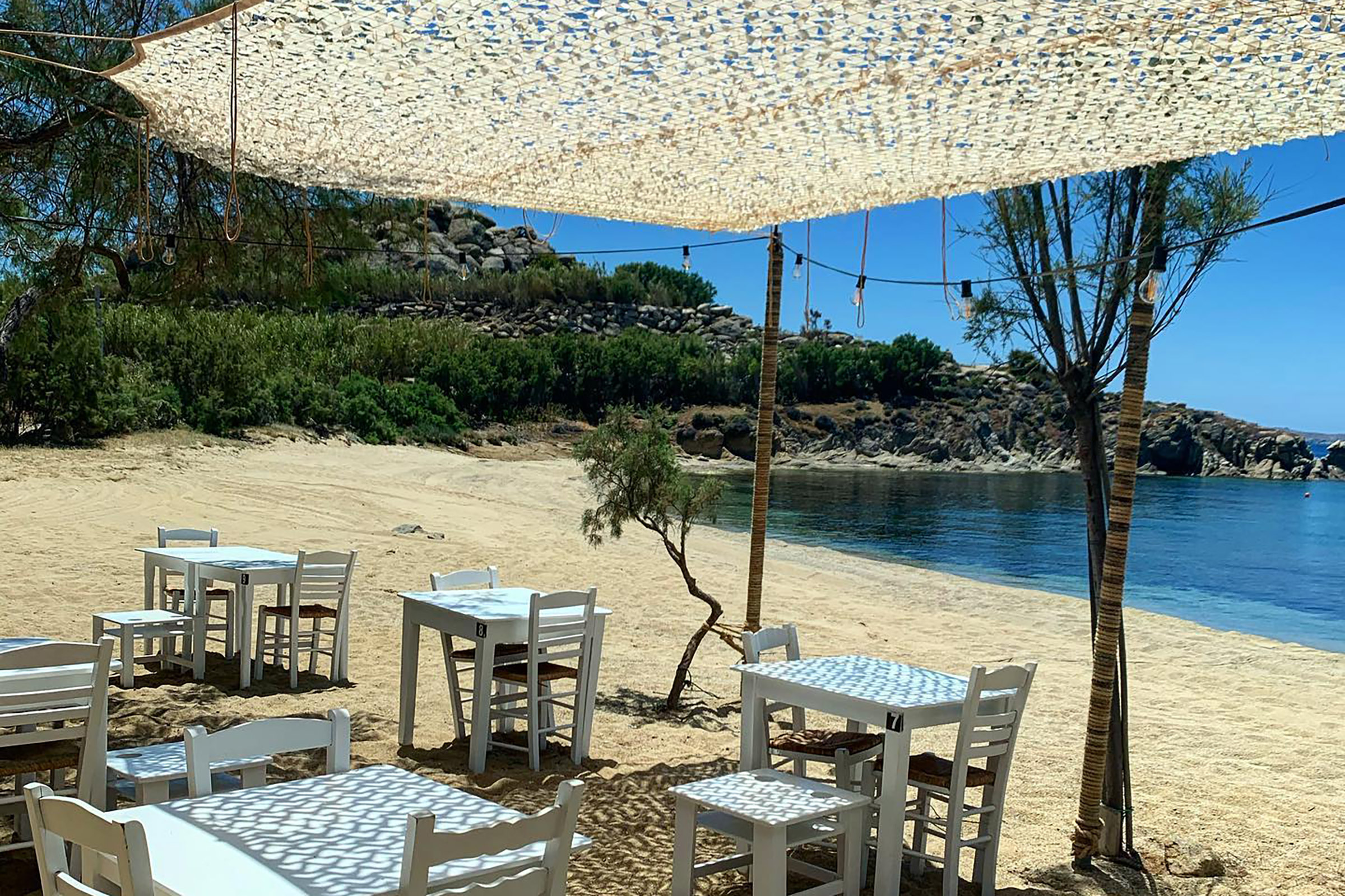Laying all day under the sun and diving in and out of the cool Aegean sea, now that is what summer holidays are all about. But let’s make it even better, let’s add a small family tavern with amazing local cuisine, just there, on the sand, a few feet from your comfy sunbed. Now we are talking, right? - Secondary Image